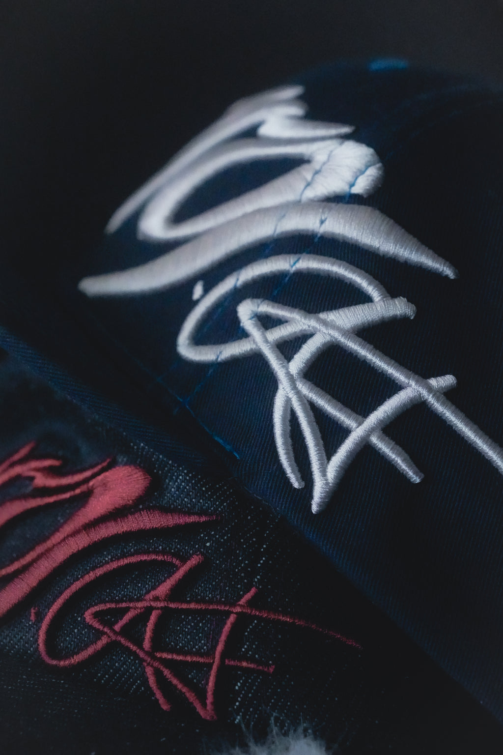 Close-up of the fitted cap with white 3D puff embroidery. 