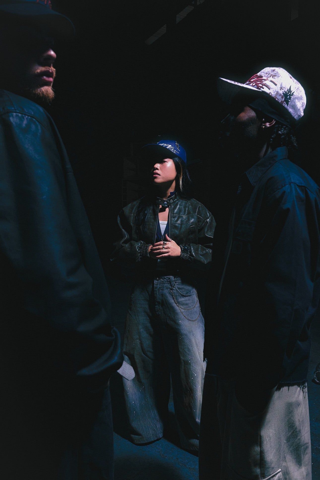 Three creatives positioned at varying depths and looking at different directions. They each wear their own custom  ANTIFRAGILE Hat, featuring the three unique silhouettes designed together with the AFDEPT. community.